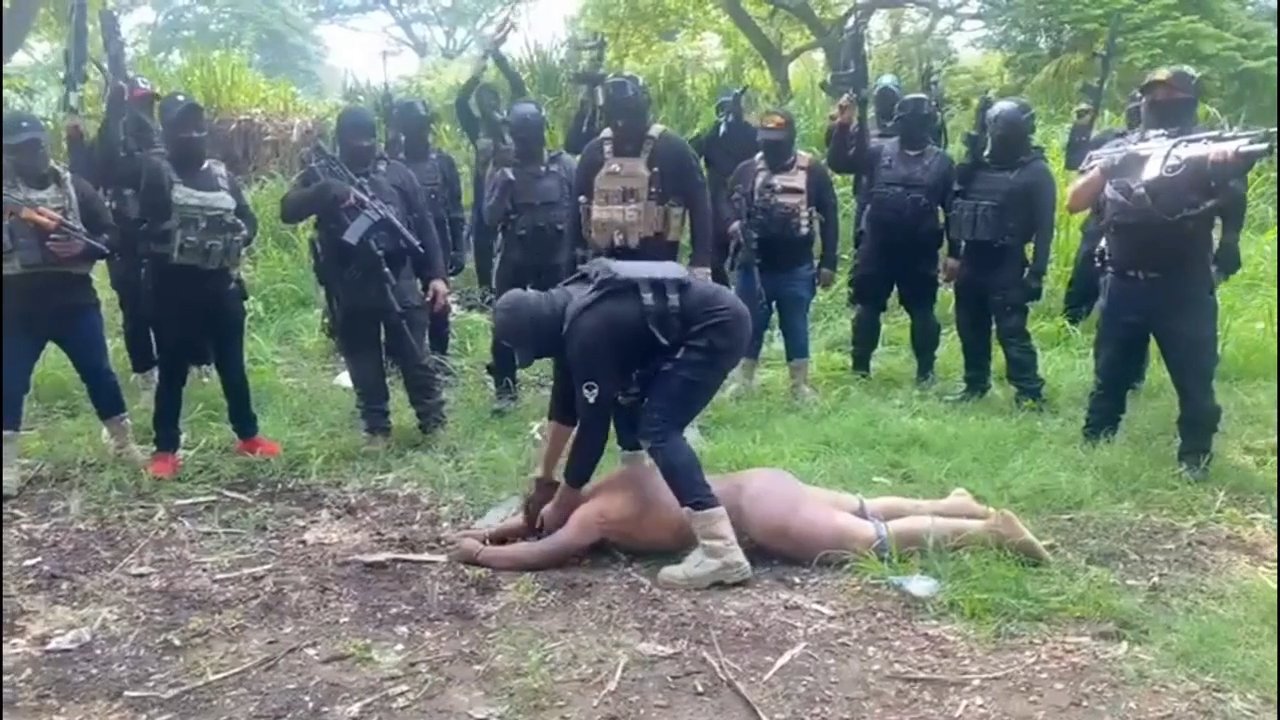 Execution of a naked man by a cartel.